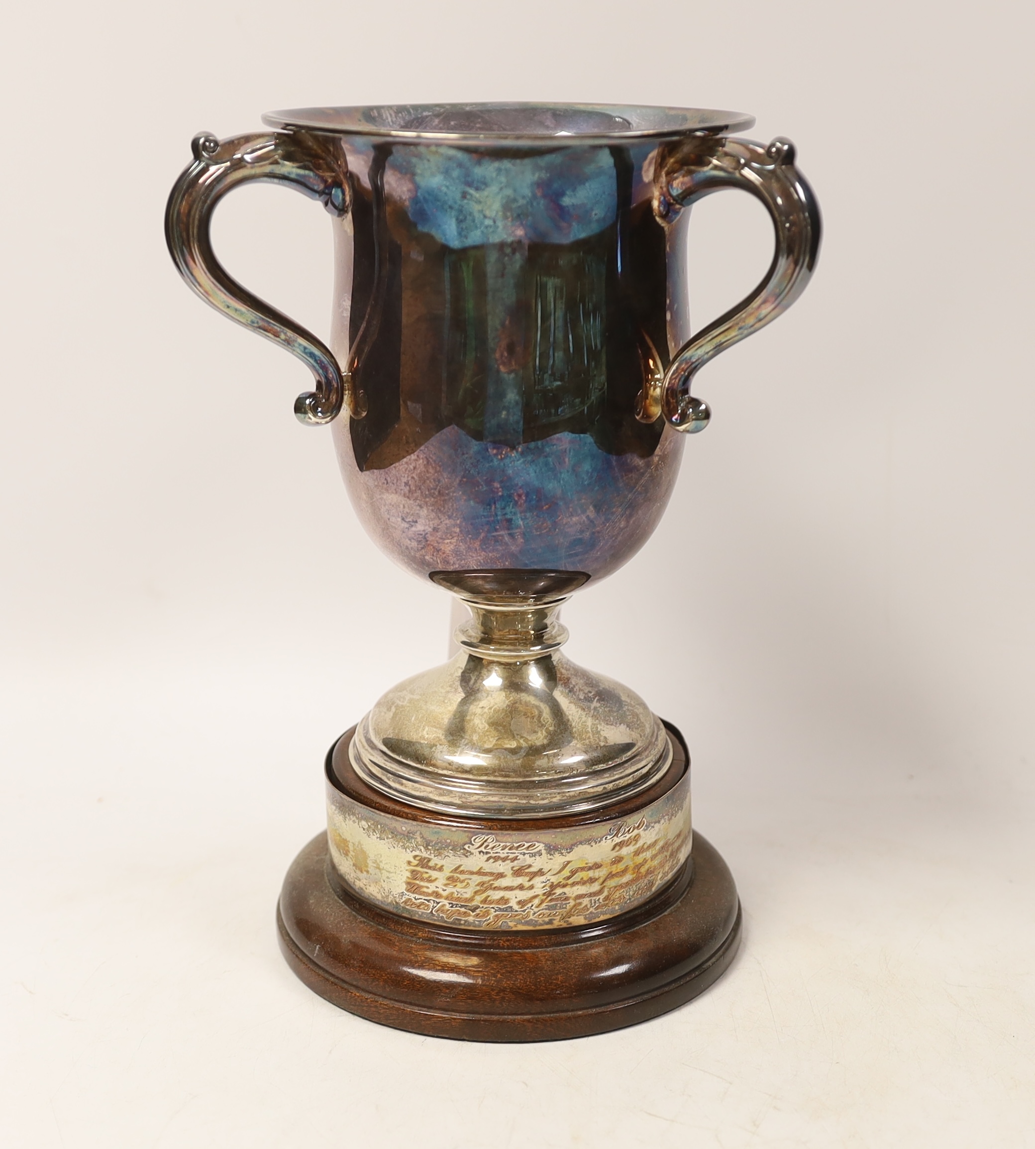 A George V tri handled silver presentation cup, T. Wilkinson & Sons, Birmingham, 1923, height, 18.9cm, 15.1oz, on a circular socle.